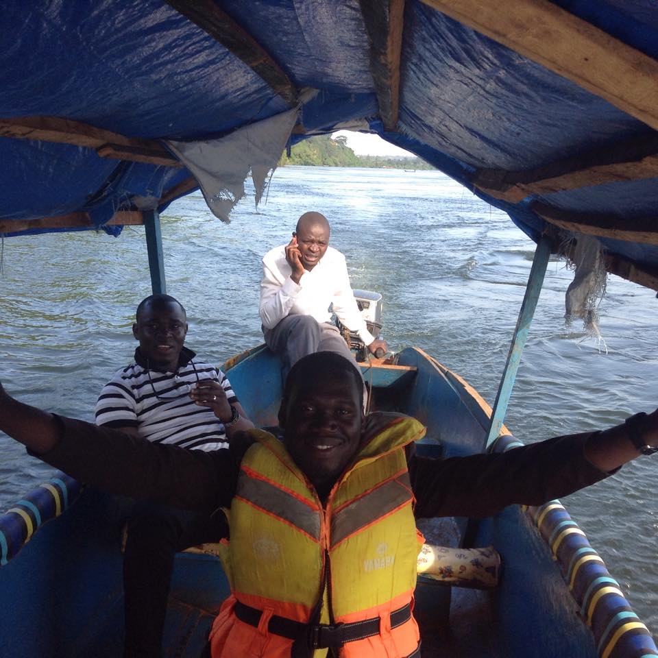 Hon Kivumbi Earnest Benjamin in a life jacket, Ps Bweyinda David and unknown sailor on a boat ride at the Source of River Nile in Jinja